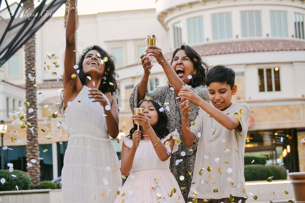 Family celebration photography in Las Vegas — family throwing confetti together