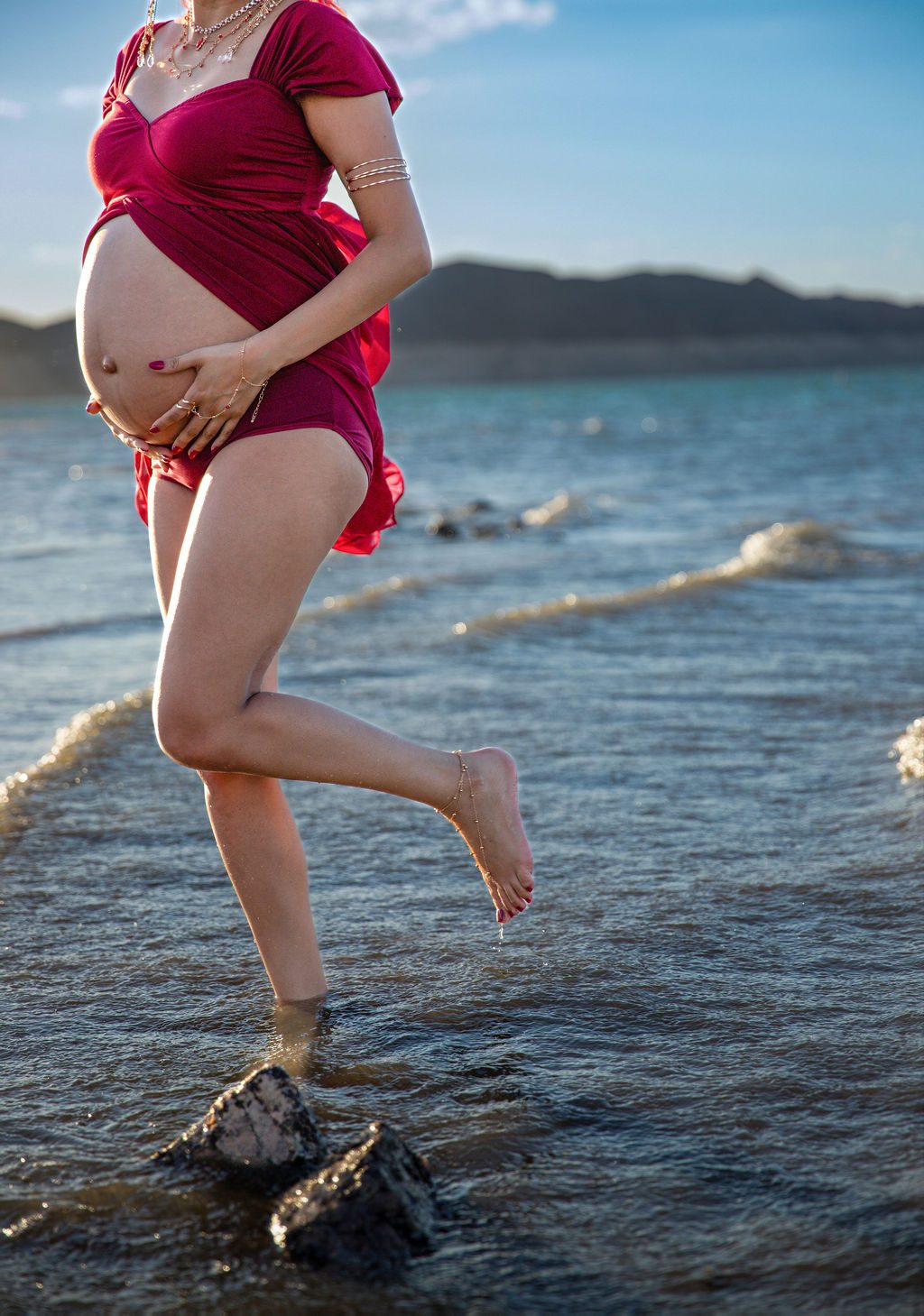 Maternity photography near Las Vegas — expecting mother stepping through lake water
