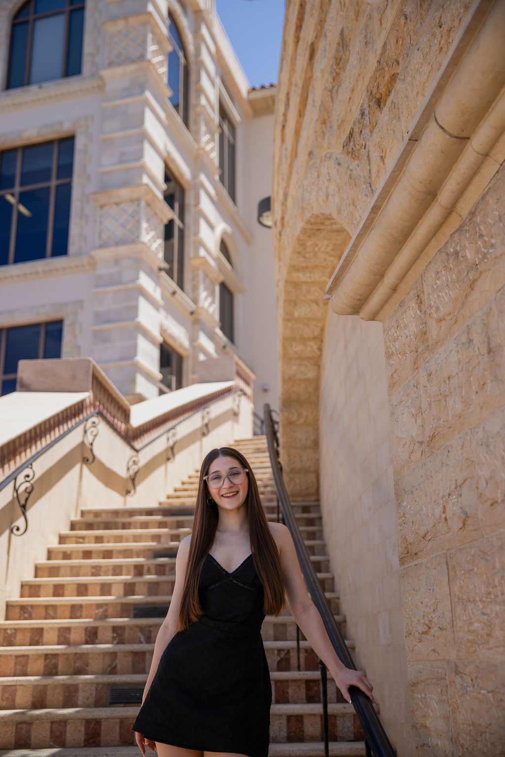 Senior portrait photography in Las Vegas — graduate on a stone staircase
